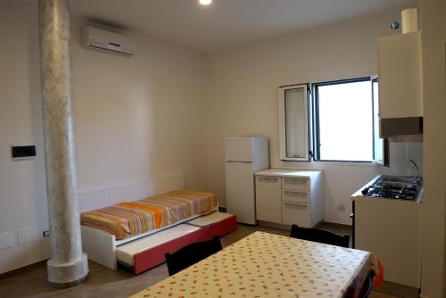 a small room with a bed and a table at Villa Sofia in Porto Cesareo