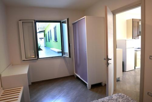 a room with a large window and a hallway at Villa Sofia in Porto Cesareo