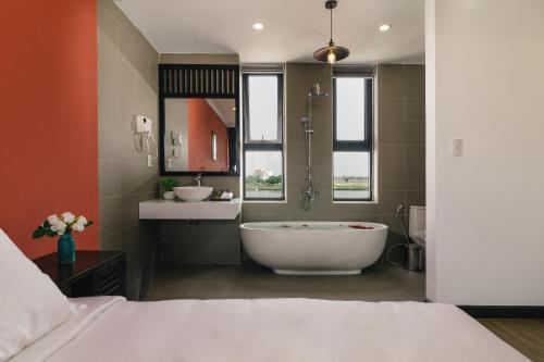 會安的住宿－La An Central Boutique Villa，带浴缸和盥洗盆的大浴室