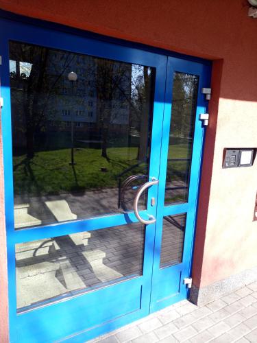 a blue door with a view of a park at Apartmány Karviná in Karviná