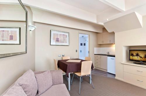 a kitchen and dining room with a table and a couch at Comfort Inn On Raglan in Warrnambool