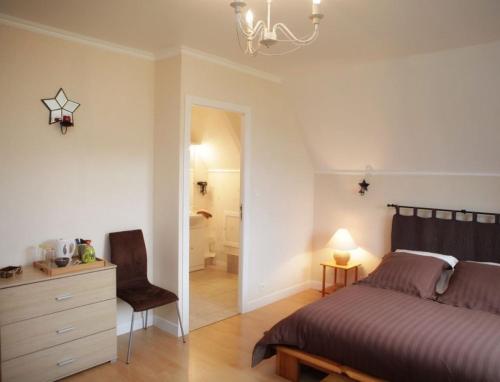a bedroom with a bed and a desk and a chair at Ker Paula in Plessala