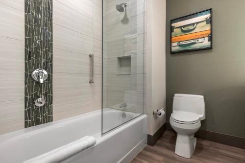 a bathroom with a toilet and a glass shower at Cambria Hotel - Arundel Mills BWI Airport in Hanover