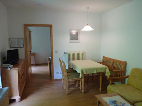 a living room with a table and a couch at Appartements Lärchenhof in Bad Kleinkirchheim