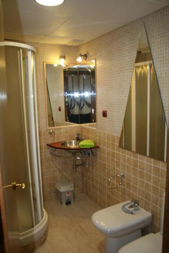 a bathroom with a toilet and a sink and a mirror at Villa Costa. in Tossa de Mar