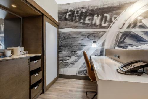 an office with a desk with a keyboard and a phone at Cambria Hotel - Arundel Mills BWI Airport in Hanover