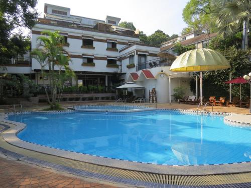 a swimming pool with a pool table and chairs at King's Garden Villa in Baihe