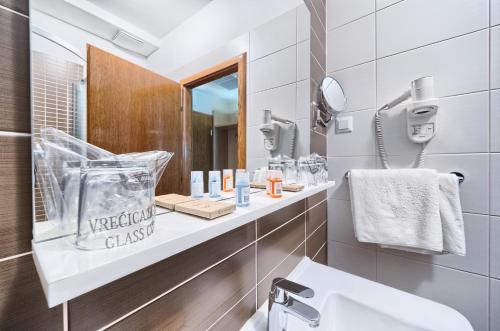 a bathroom with a sink and a mirror at Hotel Panorama in Šibenik