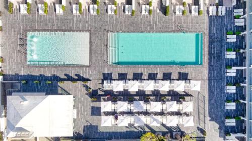 an overhead view of two swimming pools and a resort at Ura Lara Adults Only in Puerto Rico de Gran Canaria