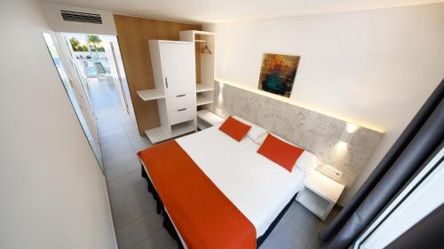 a small room with a bed and a window at Ura Lara Adults Only in Puerto Rico de Gran Canaria