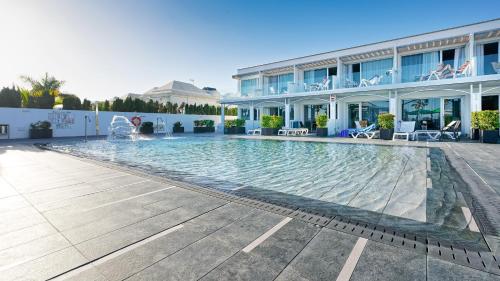 a large swimming pool in front of a building at Ura Lara Adults Only in Puerto Rico de Gran Canaria