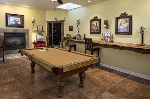 a pool table in a room with a fireplace at High Ridge Manor in Paso Robles