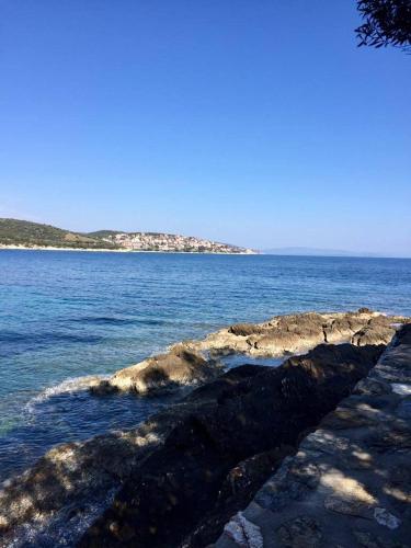 a large body of water with an island in the distance at Villa Valia: Traditional Luxurious Residence in Pyrgadikia