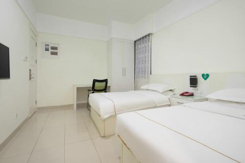 Cama o camas de una habitación en Jinxinwu Aparthotel Yuancun