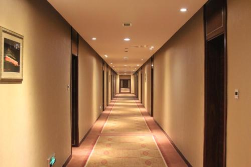 a corridor in a building with a long hallway at Soluxe Hotel Almaty in Almaty
