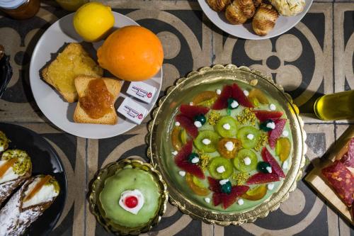 a table topped with plates of food and fruit at B&B WelcHome in Enna