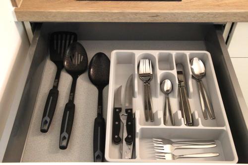 a drawer filled with utensils in a kitchen at Easy Stay Apartment in Oberboihingen