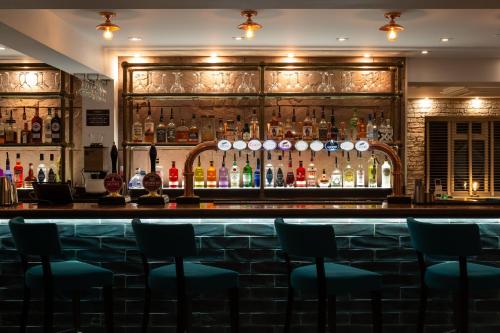 a bar with a lot of bottles of alcohol at The Kinderton in Middlewich