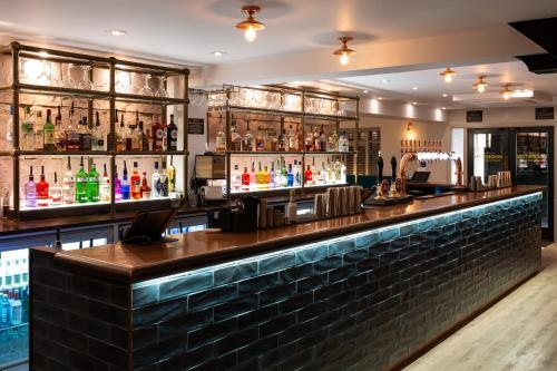 a bar in a restaurant with a lot of alcohol at The Kinderton in Middlewich