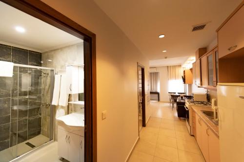 a bathroom with a sink and a glass shower at Entes Apart in Istanbul