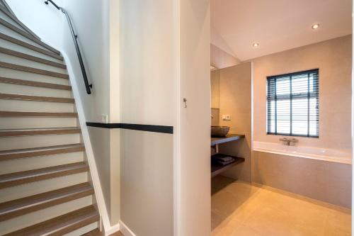 a staircase in a house with a bathroom at Boerderijwoning in Serooskerke