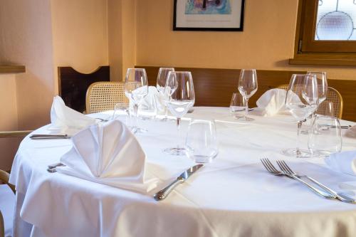 a table with wine glasses and napkins on it at Hotel Centro in Torre Pellice