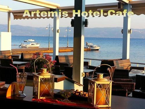 a restaurant with a table with a view of the ocean at Artemis Hotel in Amarinthos