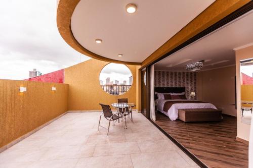 a bedroom with a bed and a table and chairs at Foz Plaza Hotel in Foz do Iguaçu