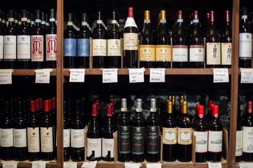 a bunch of wine bottles on display in a store at Hotel Centro in Torre Pellice