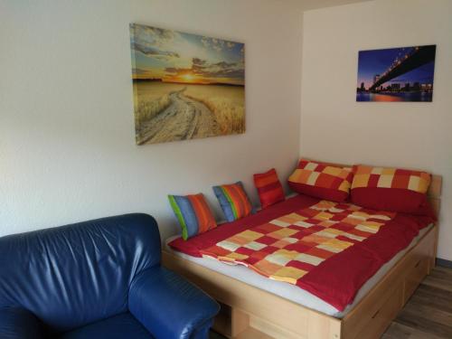 a bedroom with a bed with a checkered blanket at Ferienappartement Trier in Trier