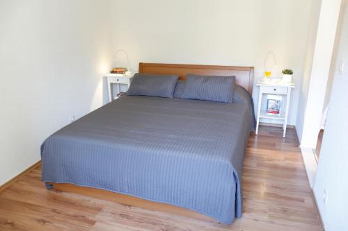 a bed in a room with two night stands at Apartment Marijana in Dubrovnik