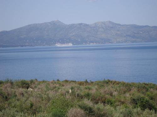 a large body of water with mountains in the background at Erdeti Boutique Hotel in Sarandë