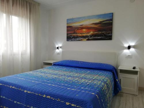 A bed or beds in a room at Appartamento Le Magnolie 2