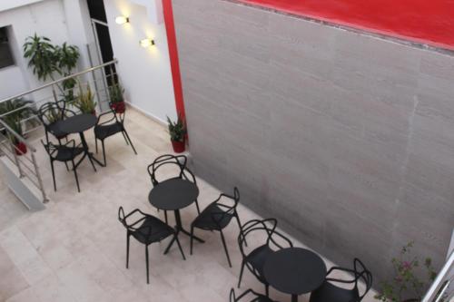 a group of tables and chairs on a patio at Hotel Monterrey in Barranquilla