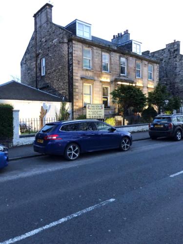 a blue car parked on the side of a street at Park View House in Edinburgh