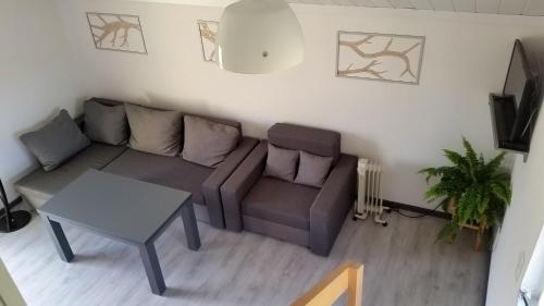 a living room with a couch and a table at Domek Pod Brzozami in Świnna