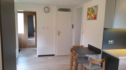 a kitchen and dining room with a table and chairs at Domek Pod Brzozami in Świnna