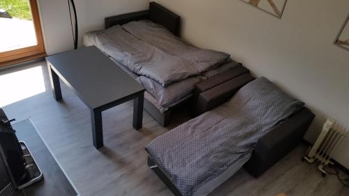 a small room with a desk and a bed at Domek Pod Brzozami in Świnna