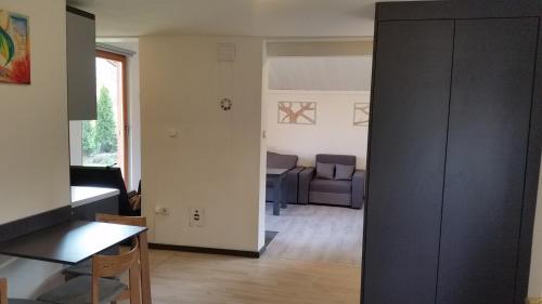 a living room with a couch and a table at Domek Pod Brzozami in Świnna