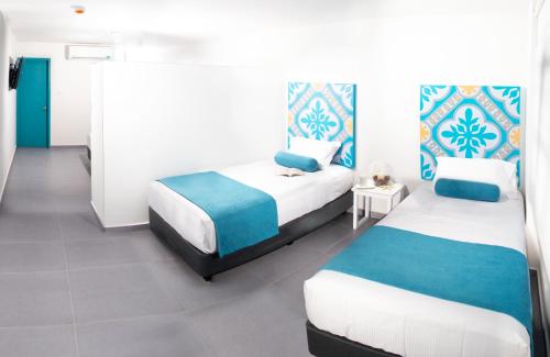 Postel nebo postele na pokoji v ubytování Akuamarina Hotel