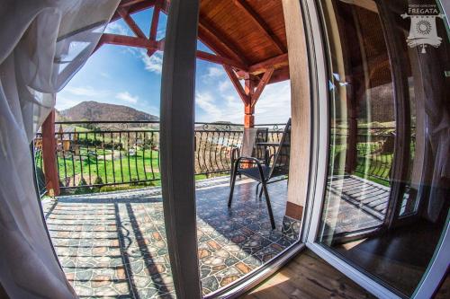 a window with a view of a mountain view at Noclegi Fregata - Pokoje Gościnne w Solinie 661-459-339 in Solina