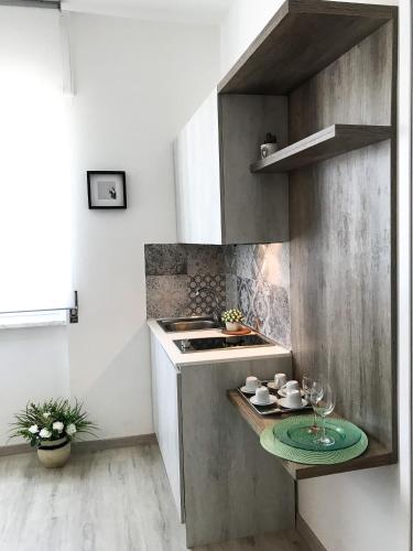 a kitchen with a stove and a plate on a counter at VIATOREM Suites in Torre dell'Orso