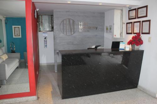 a room with a black counter in a room with a couch at Hotel Monterrey in Barranquilla