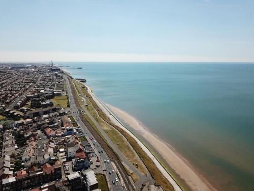 an aerial view of a beach and the ocean at Granada Apartments Queen's Promenade in Blackpool