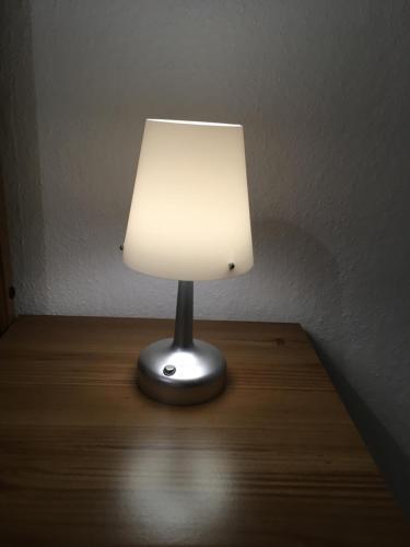 a lamp sitting on top of a wooden table at Ferienwohnung "Zur Wilke" in Stadt Wehlen