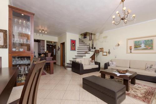 a living room with a couch and a table at Mario's house in Kallirakhi