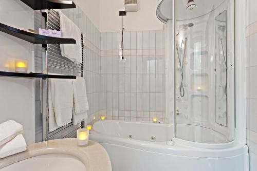 
a bathroom with a shower, sink, and toilet at Hotel Olimpia in Avezzano
