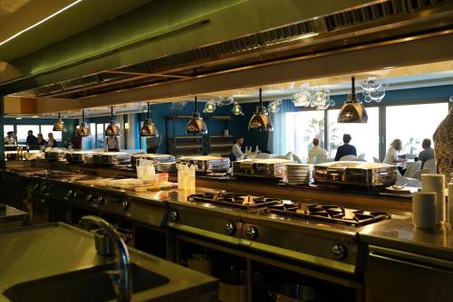 a large kitchen with a bunch of counter tops at Almyros Beach in Acharavi