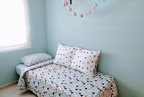 a bed with pillows on it in a room at Nuestra Casa en Gran Alacant in Gran Alacant