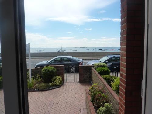 a view of two cars parked in a parking lot at WynnStay Studio Apartments in Southend-on-Sea